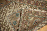 Vintage Sparta rug's tattered fringe and patterned border detail, showing sand, blue, blush tones.