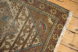 Corner detail of Vintage Sparta rug, featuring wooded floral border and tattered fringe.