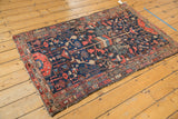 Vintage Hamadan rug displaying serrated tree-of-life, rectilinear vinery in navy, red, ivory tones, and worn ends.