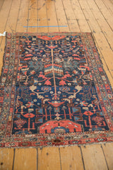 Vintage Hamadan rug border detail: serpent and boteh motifs in brick red, navy, ivory.