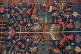 Navy, madder red, and teal rectilinear vinery with visible foundation on vintage Hamadan rug.
