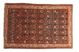 Hand knotted vintage Malayer rug: dark navy field with tangerine, blush, ivory floral pattern.