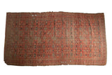 Tattered Antique Beshir carpet with allover lattice design in madder red, navy, and ivory.