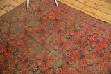 Antique Beshir carpet's madder red field, showing lattice pattern with extensive foundation wear.