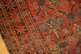 Storied madder red Beshir pile, navy and teal geometric lattice, exposed foundation.