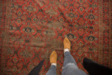 Section of antique Beshir carpet, displaying lattice design, madder red, navy, and visible foundation.