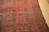Tattered antique Beshir carpet, featuring madder red field with exposed foundation and worn lattice pattern.