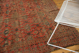 Antique Beshir carpet's allover lattice, madder root red, showing prominent wear and exposed foundation.