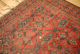 Antique Beshir carpet detail: geometric red, blue, ivory pattern with foundation wear and tattered fringe.