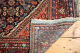 Hand-knotted vintage Persian Mahal rug corner reveals navy, red patterns and visible foundation.