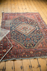 Intricate patterns on vintage Persian Mahal rug's navy blue field and blush red border.