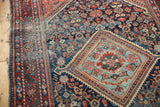 Vintage Mahal rug's diamond medallion, with powder blue, navy, and blush floral patterns.