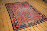 Cherry red Lilihan rug, featuring a floating Herati motif and navy blue traditional borders.