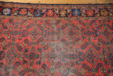 Vintage Lilihan rug field showcasing floating Herati motifs in cherry red and cobalt blue.