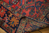 Vintage Lilihan rug folded corner, showing red, navy Herati pattern, secure edge.