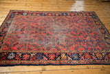 Vintage Lilihan rug, angled view with low cherry red pile and Herati motif.