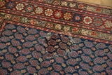 Rewoven navy boteh field and red floral border on a vintage Northwest Persian rug.