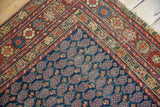 Vintage Northwest Persian rug corner, showcasing navy boteh field and vivid floral borders.