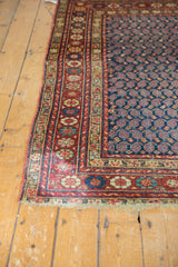 Vintage Northwest Persian rug corner, cherry red floral border, navy boteh field.