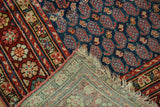 Close view of a vintage Northwest Persian rug's patterned pile and hand-knotted foundation.
