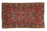 Vintage Persian Lilihan rug, central medallion, floral patterns: red, blue, green.