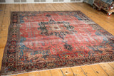 Antique Farahan Sarouk rug corner with raspberry field and classic navy floral border.