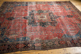Antique Farahan Sarouk with raspberry red field, delicate floral tendrils, and navy border.