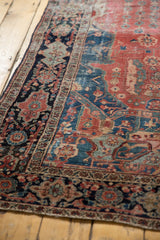 Classic Farahan Sarouk border on navy ground, floral motifs, and worn raspberry field.