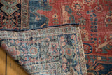 Intricate hand-knotted foundation and classic navy border detail of an antique Farahan Sarouk rug.