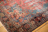 Farahan Sarouk rug corner with classic navy border and a field of raspberry and sky blue florals.