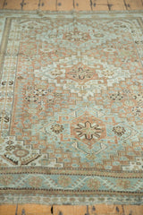 Detail of distressed vintage rug: worn geometric field and border patterns in copper, sea foam.