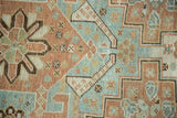 Distressed texture, geometric copper and sea foam patterns on the vintage Shiraz rug.