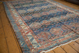Baktiari rug with distressed geometric border, allover panels in sky blue, blush, cherry red.