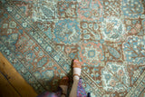 Vintage distressed Baktiari carpet detail showing Garden of Paradise motif in terracotta, blue, blush.