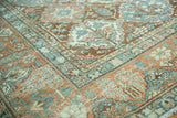 Distressed Baktiari rug corner with terracotta, slate blue, ivory Gardens of Paradise motifs.