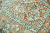 Distressed copper terracotta and teal floral patterns with softened wear on a Baktiari carpet.