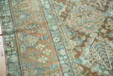 Distressed vintage Baktiari carpet detail showcasing terracotta, teal, beige 'Gardens of Paradise' motifs.