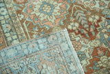 Distressed vintage Baktiari rug corner, showing worn terracotta, teal pile and foundation.