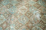 Distressed vintage Baktiari rug detail, showing traditional pattern in terracotta, blush, and slate blue.