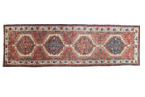 Vintage Serab runner with geometric cherry red and navy medallions. 3'1