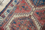 Vintage Serab rug with classic cherry red, sky blue, camel geometric patterns, floral border.