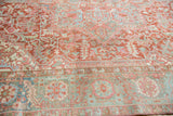 Distressed vintage Heriz rug, detail of cherry red, seafoam green, ivory rectilinear vinery and palmette border.