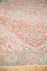 Vintage Heriz rug's distressed rectilinear vinery and palmettes in cherry red, seafoam, ivory.