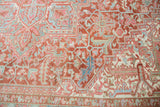 Distressed vintage Heriz rug's geometric rectilinear vinery with serrated vine motif.