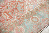 Textured distressed Heriz carpet showing rectilinear vinery, palmettes, cherry red, sea foam green.