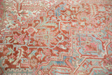 Cherry red, sea foam green, and blush geometric vinery on a vintage distressed Heriz carpet.