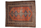 Vintage Malayer rug with triple diamond medallions, dusty rust blush field, navy blue finials, and worn pile, 5' x 6'1