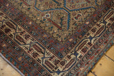Worn Malayer rug corner showing Mir Serbend border, clover motifs, and visible knot heads.