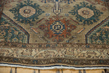 Distressed Malayer rug with worn floral palmettes, geometric borders, and secured fringe.