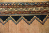 Intricate zig-zag geometric motif and variegated borders of an antique distressed Malayer rug.